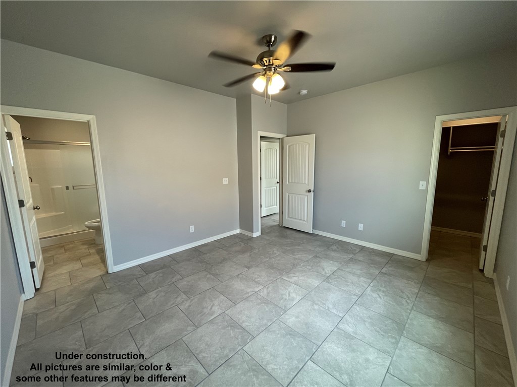 3591 North Verdugo Road Kingman, AZ 86409 - Photo 13 of 19 Spacious room featuring tile flooring, light gray walls, a ceiling fan with integrated lighting, and white trim