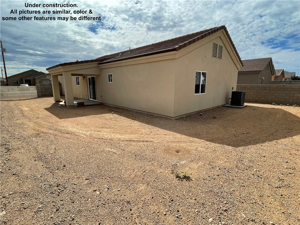 3591 North Verdugo Road Kingman, AZ 86409 - Photo 18 of 19 The property features a stucco exterior, a covered patio area, and a gravel yard