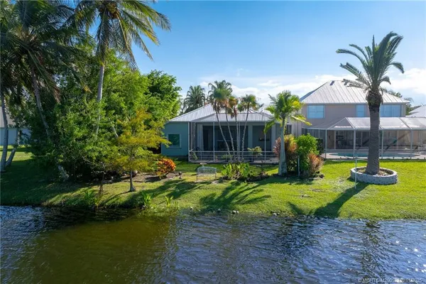 a view of a house with swimming pool and sitting area