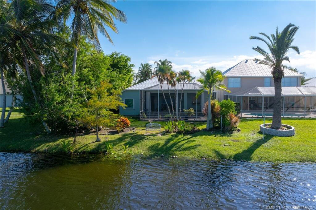895 Northwest Sassafras Terrace Stuart, FL 34994 - Photo 3 of 23 a view of a house with swimming pool and sitting area