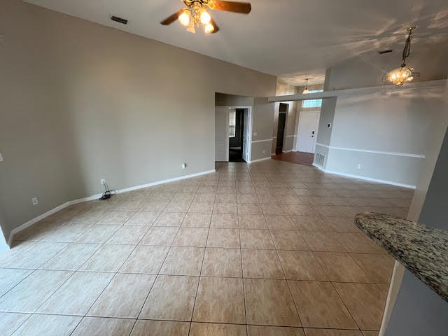 895 Northwest Sassafras Terrace Stuart, FL 34994 - Photo 5 of 23 a view of a livingroom with a chandelier fan and kitchen view