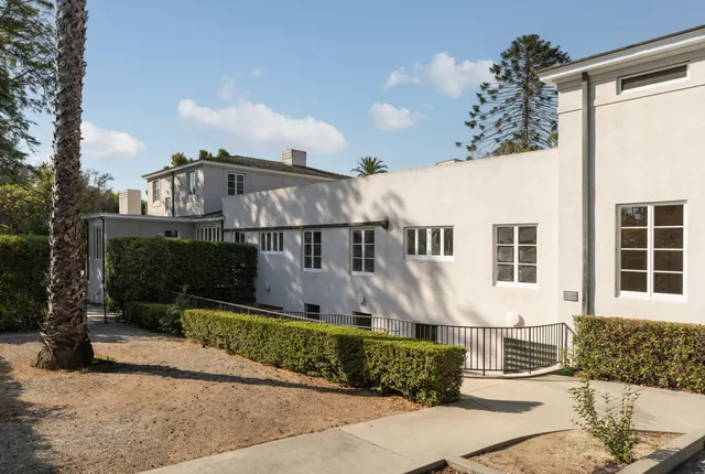 a view of backyard with outdoor seating and plants
