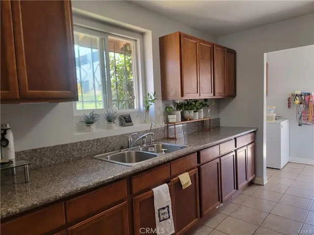 a kitchen with stainless steel appliances granite countertop a sink and a window