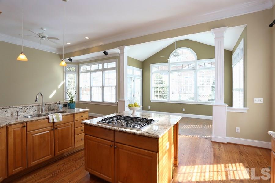 3109 Bentley Hill Road Raleigh, NC 27612 - Photo 12 of 25 a kitchen with a sink stove and cabinets