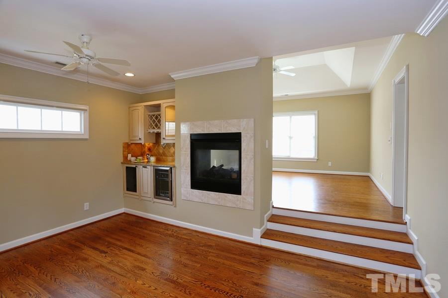 3109 Bentley Hill Road Raleigh, NC 27612 - Photo 13 of 25 a view of an empty room with wooden floor fireplace and a window