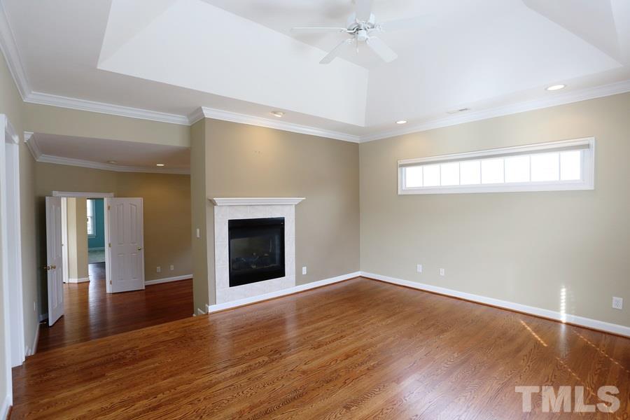 3109 Bentley Hill Road Raleigh, NC 27612 - Photo 14 of 25 a view of an empty room with wooden floor and a window