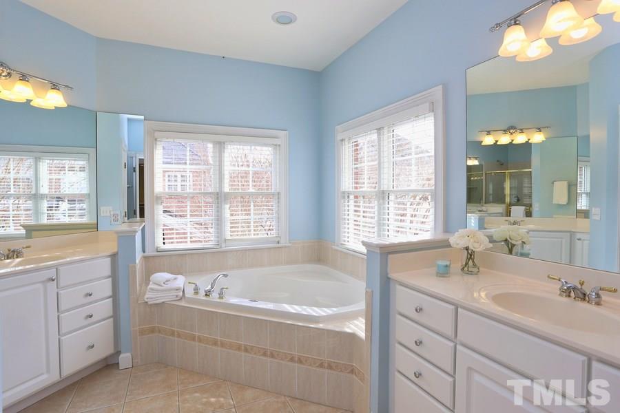 3109 Bentley Hill Road Raleigh, NC 27612 - Photo 16 of 25 a bathroom with sink bathtub double vanity and window