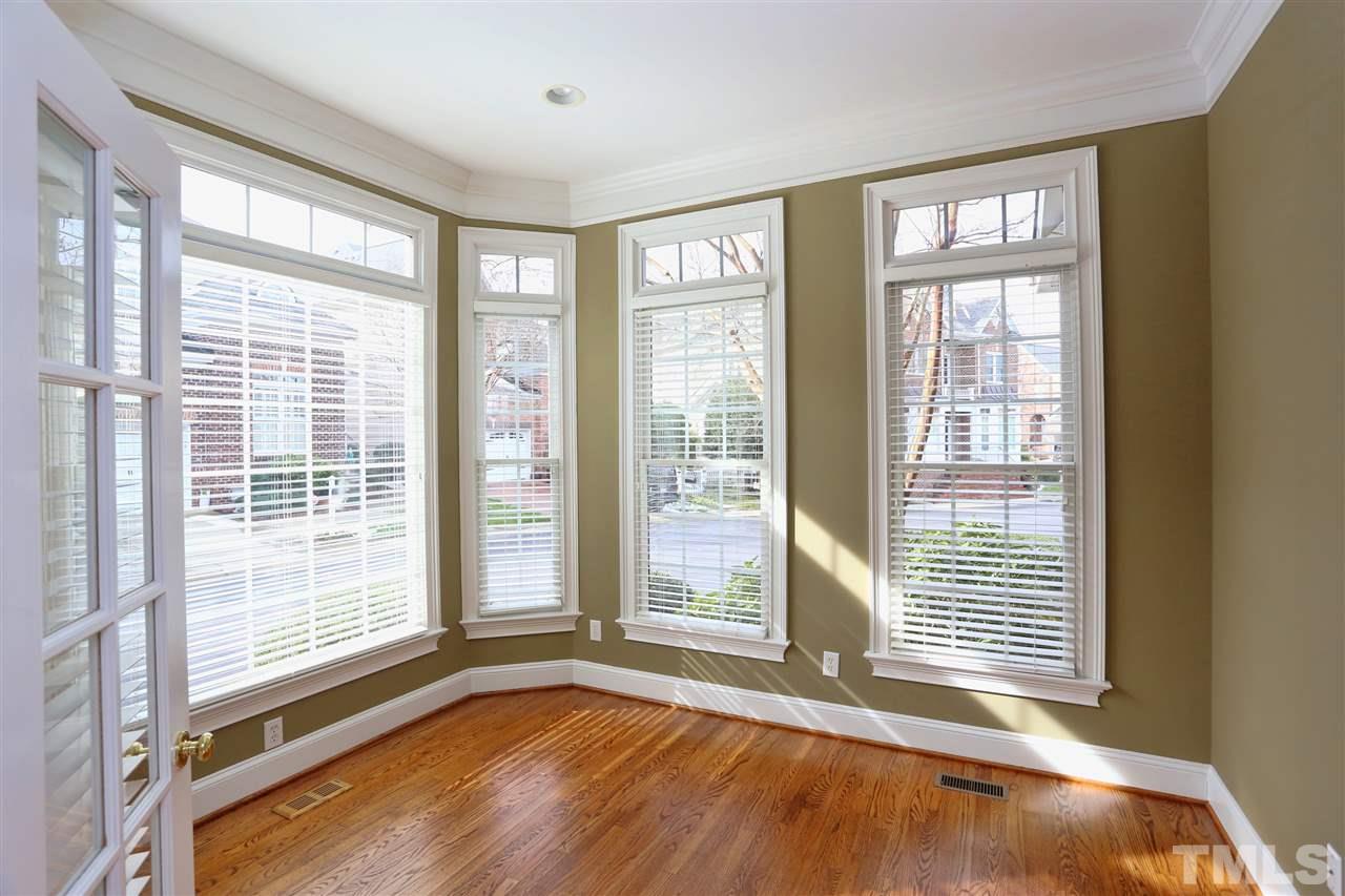 3109 Bentley Hill Road Raleigh, NC 27612 - Photo 3 of 25 a view of an empty room with a floor to ceiling window and wooden floor