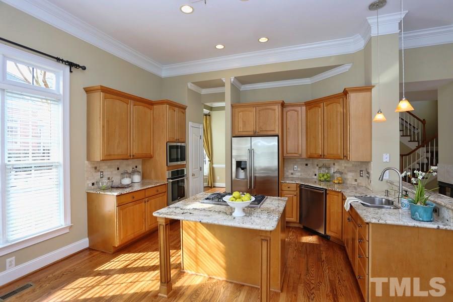 3109 Bentley Hill Road Raleigh, NC 27612 - Photo 9 of 25 a large kitchen with a table and chairs in it