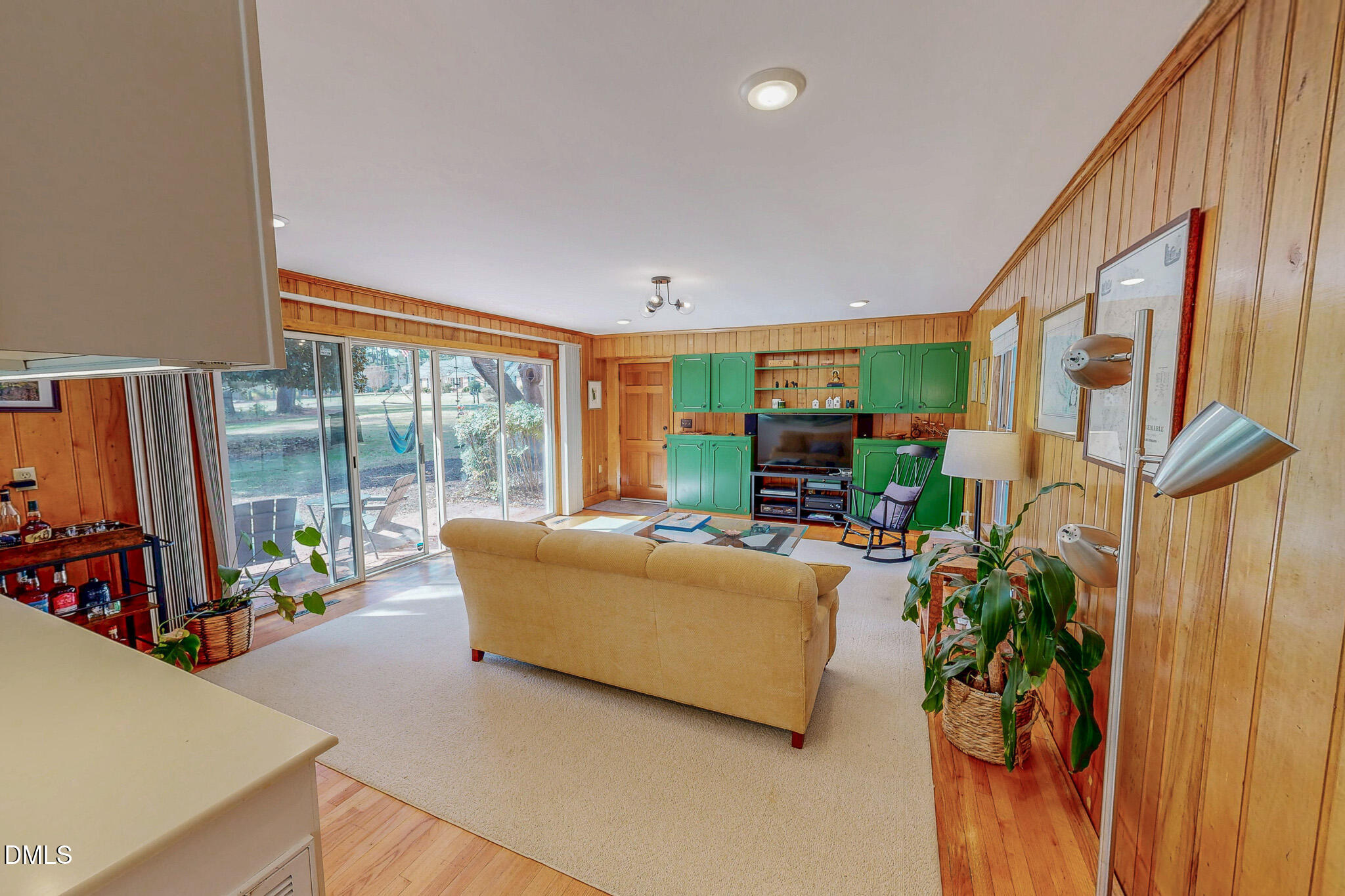 382 Wimbledon Drive Roxboro, NC 27573 - Photo 12 of 66 a living room with furniture a floor to ceiling window and a flat screen tv