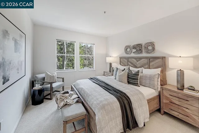 a bed room with a bed and a chair