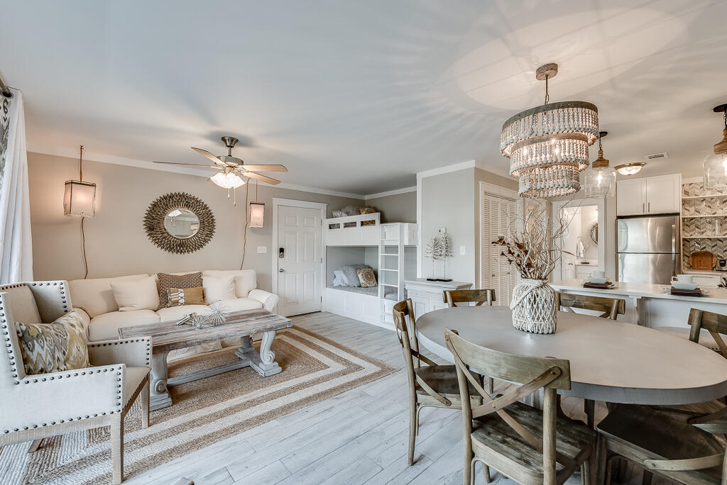 3799 East County Highway 30A, Unit C3 Santa Rosa Beach, FL 32459 - Photo 1 of 43 a dining room with wooden floor a chandelier a wooden table and chairs