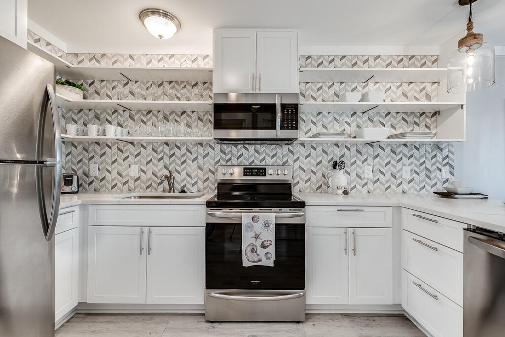 3799 East County Highway 30A, Unit C3 Santa Rosa Beach, FL 32459 - Photo 17 of 43 a kitchen with white cabinets and stainless steel appliances