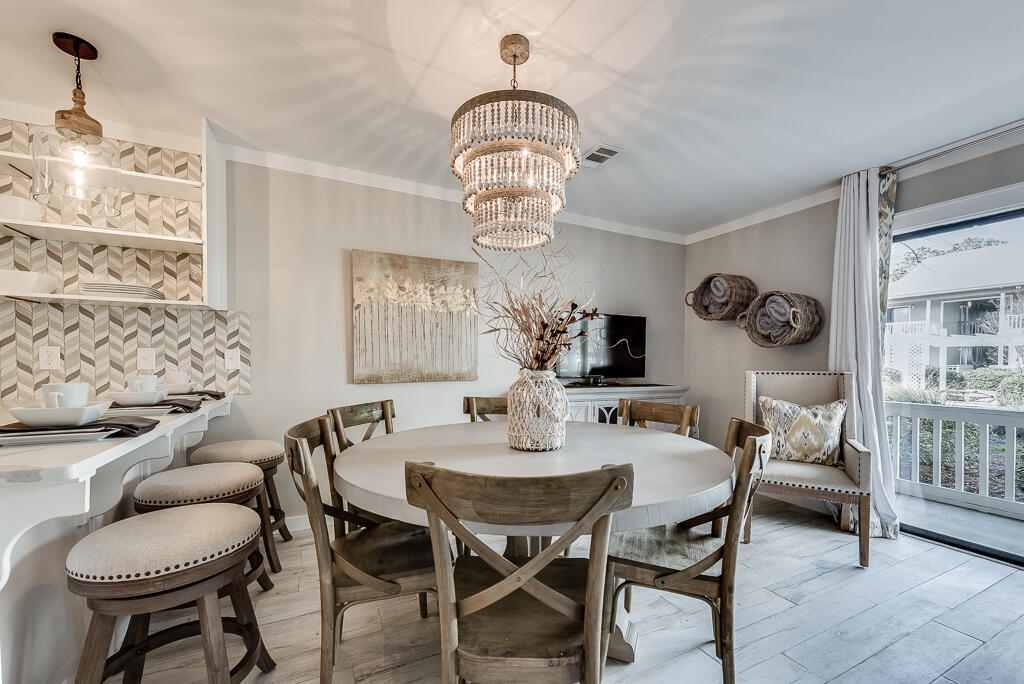 3799 East County Highway 30A, Unit C3 Santa Rosa Beach, FL 32459 - Photo 3 of 43 a view of a dining room with furniture and a chandelier