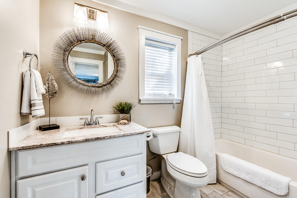 3799 East County Highway 30A, Unit C3 Santa Rosa Beach, FL 32459 - Photo 29 of 43 a bathroom with a granite countertop toilet a sink and a mirror