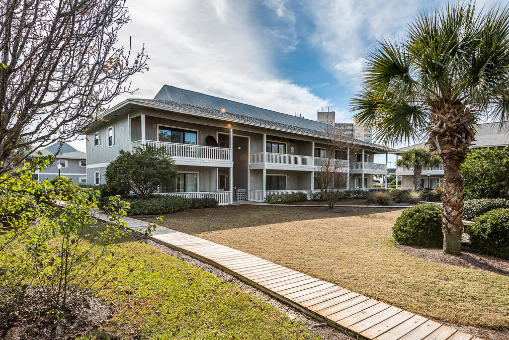3799 East County Highway 30A, Unit C3 Santa Rosa Beach, FL 32459 - Photo 30 of 43 a front view of a house with a garden and plants