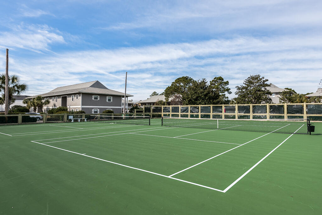 3799 East County Highway 30A, Unit C3 Santa Rosa Beach, FL 32459 - Photo 35 of 43 a view of a tennis ground with a big yard and large trees