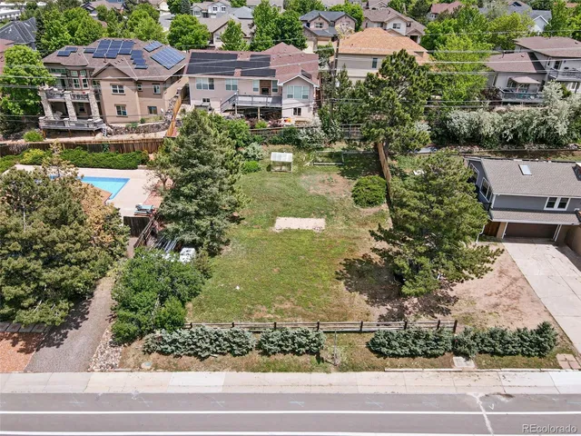 an aerial view of residential houses with city view