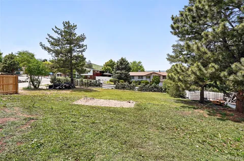 a view of yard with swimming pool and trees