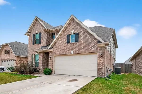 an empty room with chandelier fan and window