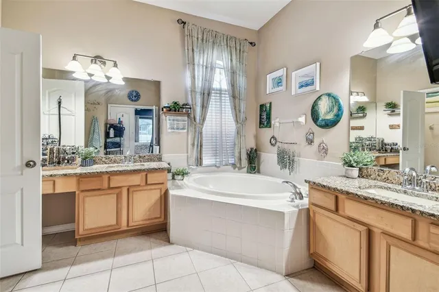 a bathroom with a double vanity sink mirror and shower