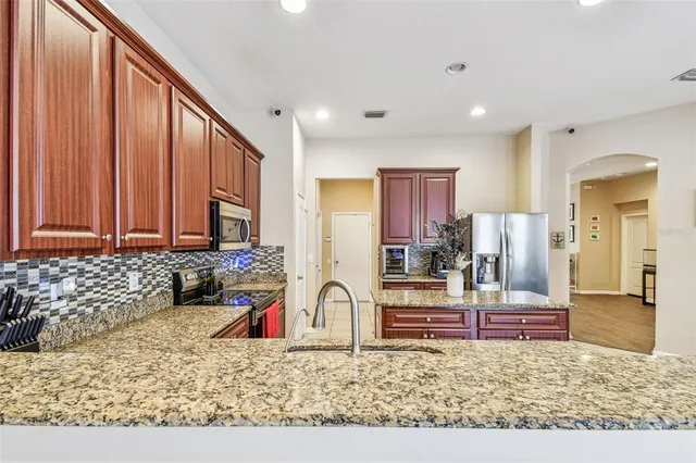 a kitchen with granite countertop counter top space a sink stainless steel appliances and cabinets