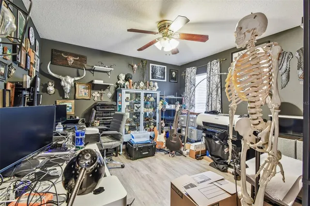 a living room with fish tank and a bookshelf