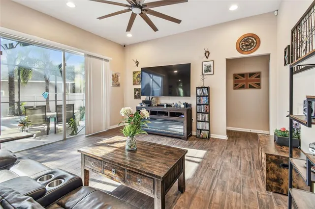 a living room with furniture and a wooden floor