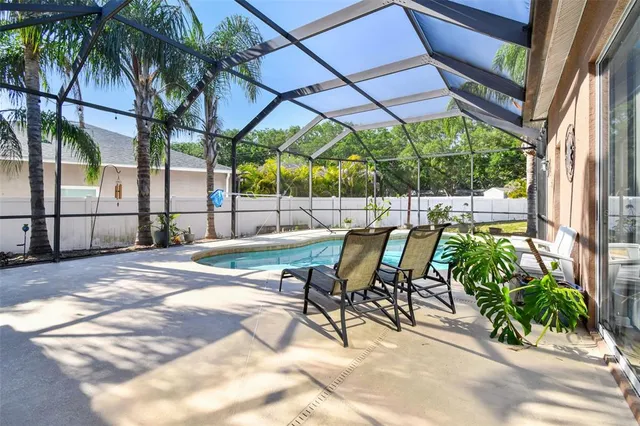 a view of a patio with table and chairs under an umbrella