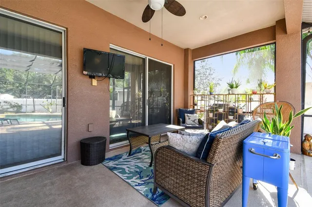 a living room with furniture and a floor to ceiling window