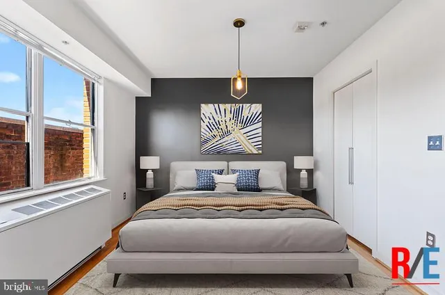 a bedroom with a bed and a window