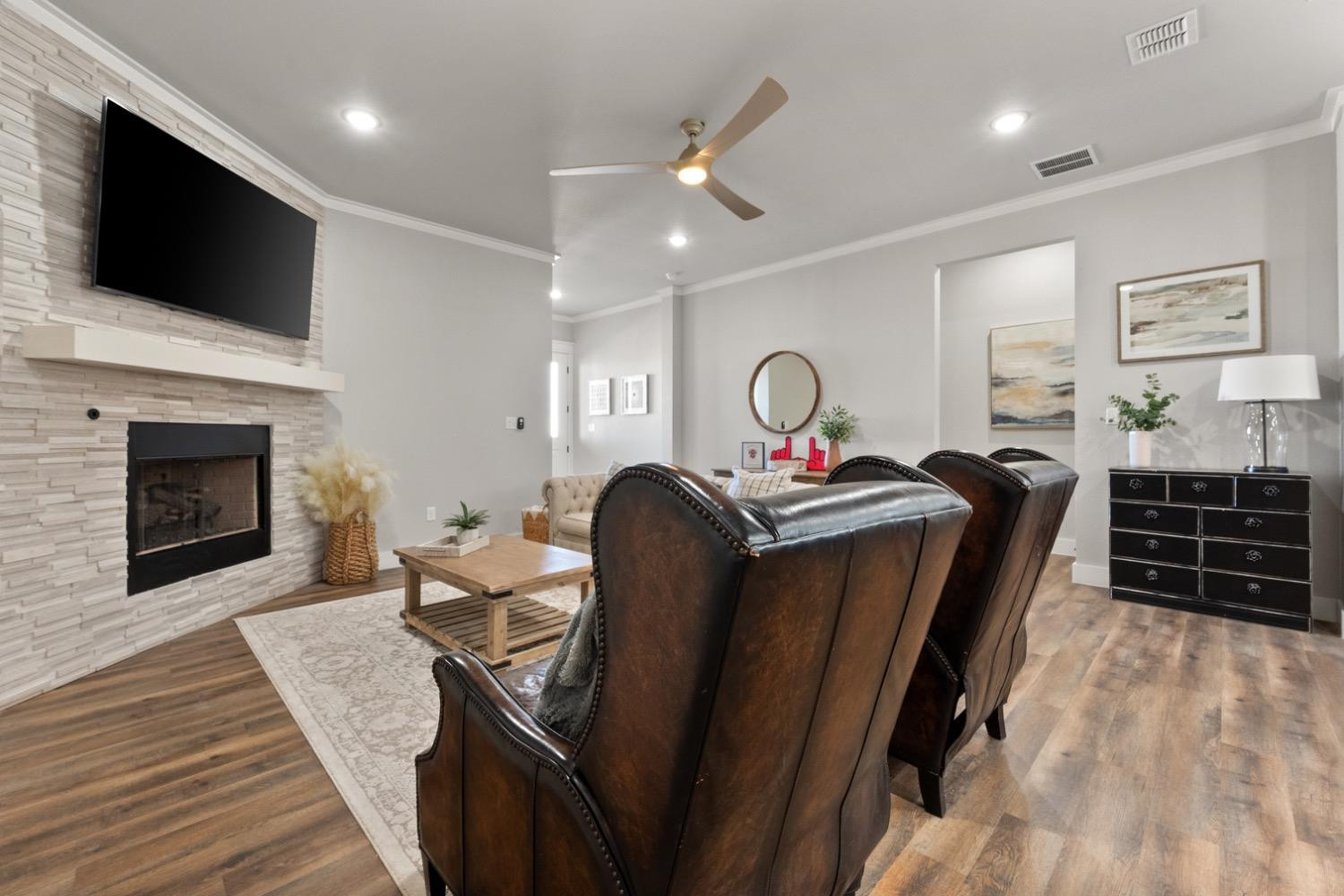 7805 52nd Street Lubbock, TX 79407 - Photo 8 of 32 a living room with furniture a fireplace and a flat screen tv