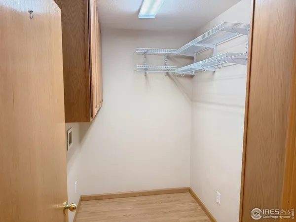 a view of walk in closet with empty racks