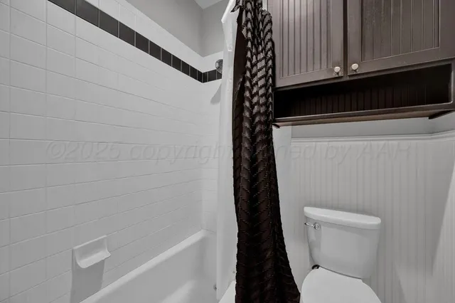 a living room with wooden floor furniture and a ceiling fan