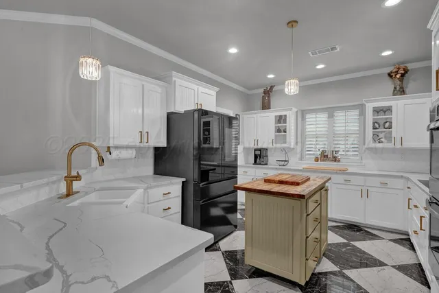 a kitchen with stainless steel appliances kitchen island granite countertop a sink and cabinets