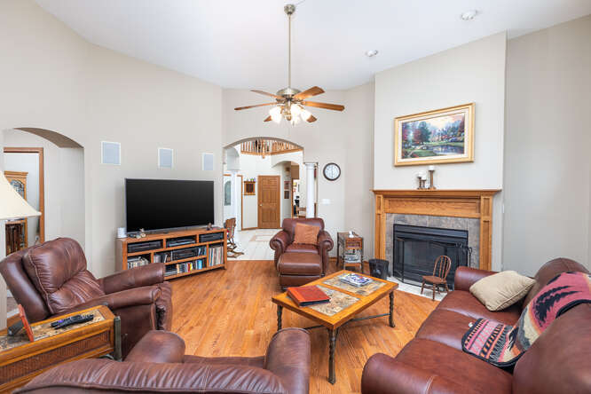 2658 East 1559th Road Ottawa, IL 61350 - Photo 23 of 53 a living room with furniture a fireplace and a flat screen tv