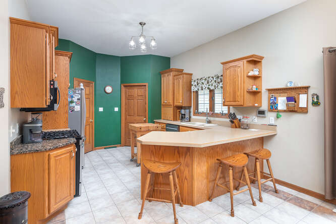 2658 East 1559th Road Ottawa, IL 61350 - Photo 27 of 53 a kitchen with stainless steel appliances kitchen island granite countertop a sink and cabinets