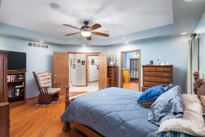 2658 East 1559th Road Ottawa, IL 61350 - Photo 31 of 53 a bedroom with a bed and furniture with wooden floor