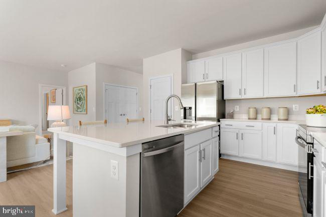 58 Outrigger Road Inwood, WV 25428 - Photo 4 of 16 a kitchen with white cabinets sink and white appliances