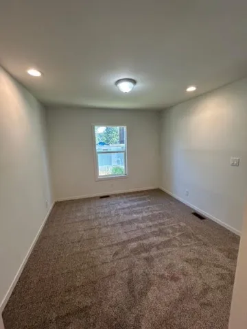 an empty room with a empty space and windows