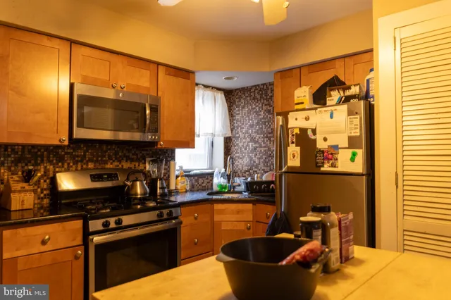 a view of outdoor kitchen with seating area