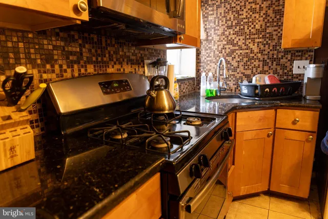 a kitchen with a sink a stove and a microwave