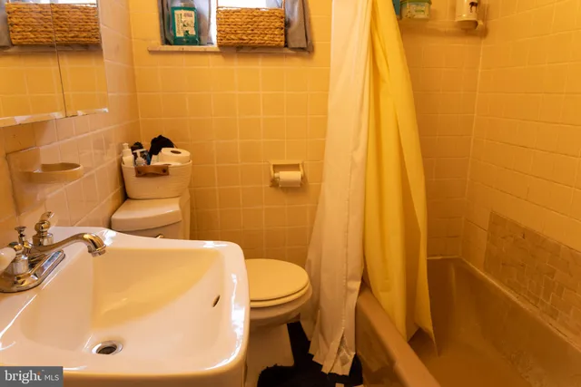 a bedroom with a bed and dresser