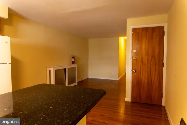 a kitchen with granite countertop cabinets stainless steel appliances a sink and a window