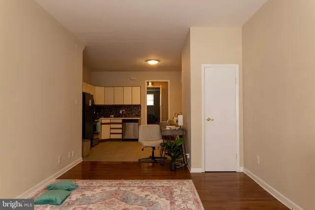 a view of living room with furniture and wooden floor