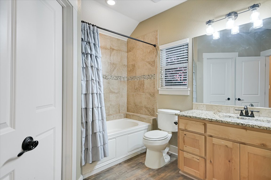 8305 Ozark Drive San Marcos, TX 78666 - Photo 14 of 34 a bathroom with a granite countertop sink toilet and shower