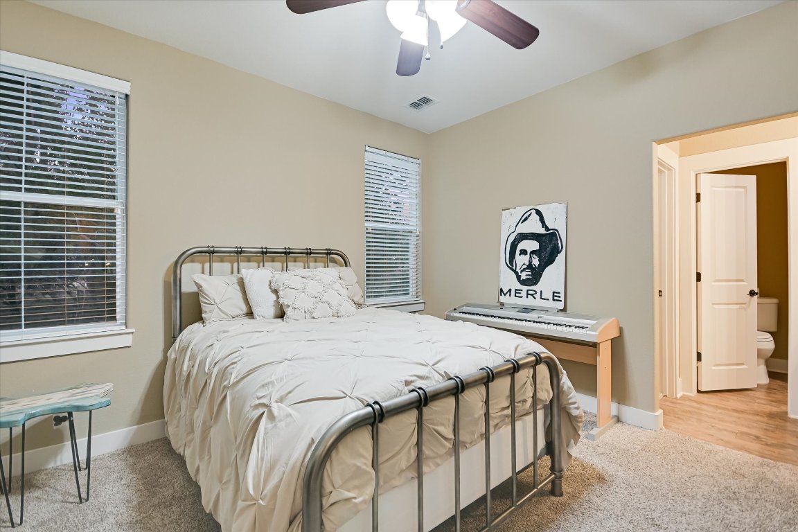 8305 Ozark Drive San Marcos, TX 78666 - Photo 17 of 34 a bedroom with a bed and a chandelier