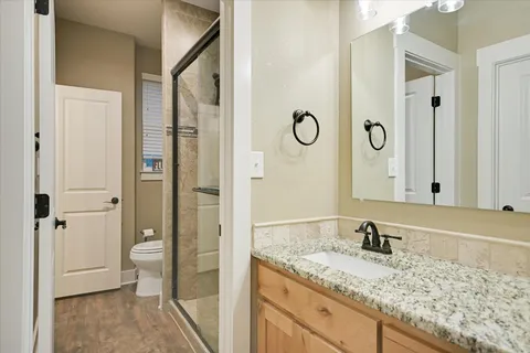 a bathroom with a granite countertop sink and a mirror