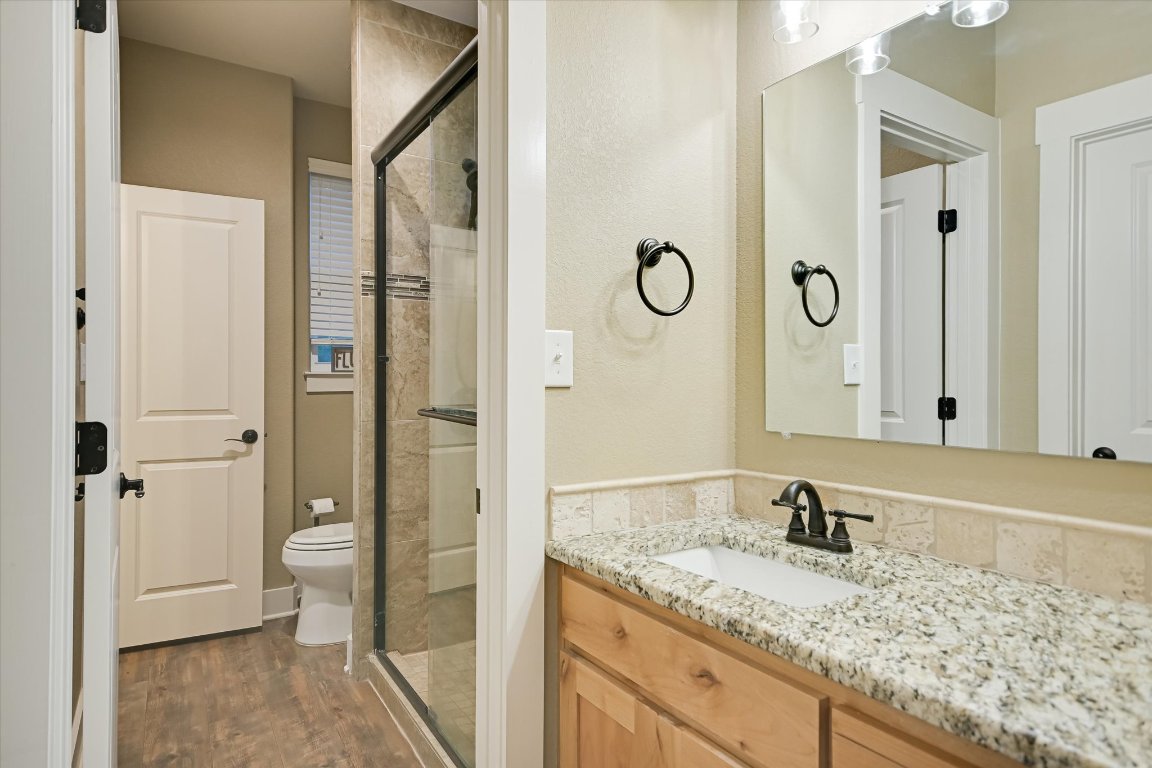8305 Ozark Drive San Marcos, TX 78666 - Photo 18 of 34 a bathroom with a granite countertop sink and a mirror