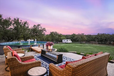 a balcony with furniture and a garden